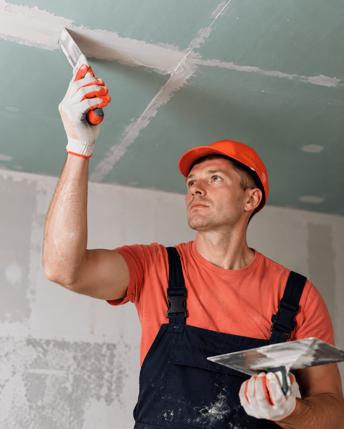 Worker repairing a ceiling surface